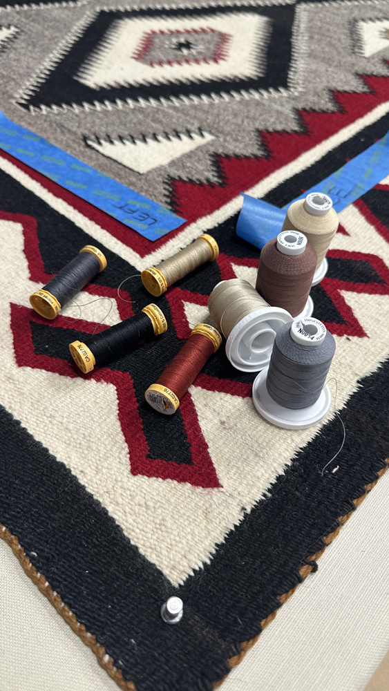 Hand stitching used in textile mounting